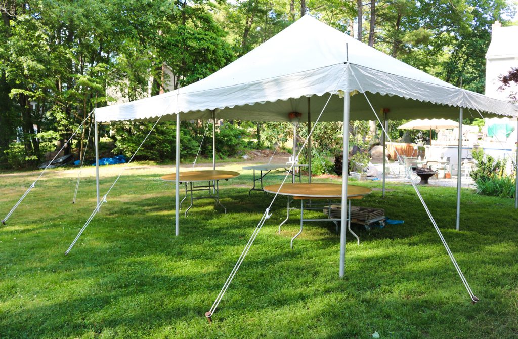 Backyard tent rental setup for an outdoor party
