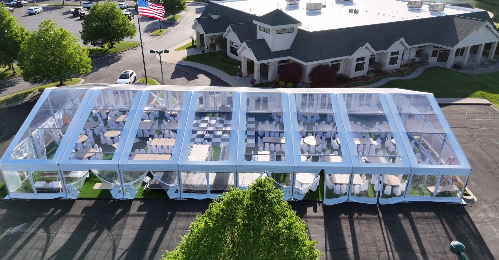 High-end clear-top structure tent wedding in Freeland, MI by Knights Tent & Party Rental