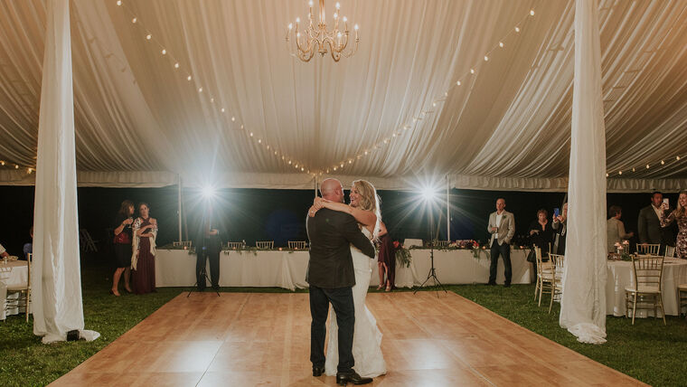 Pole tent wedding with full tent liner and dance floor in Oakland County, MI by Knights Tent & Party Rental