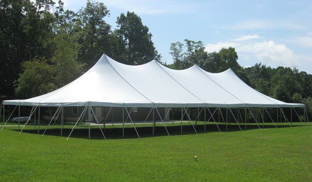 High-peak pole tent wedding in Oxford, MI by Knights Tent & Party Rental