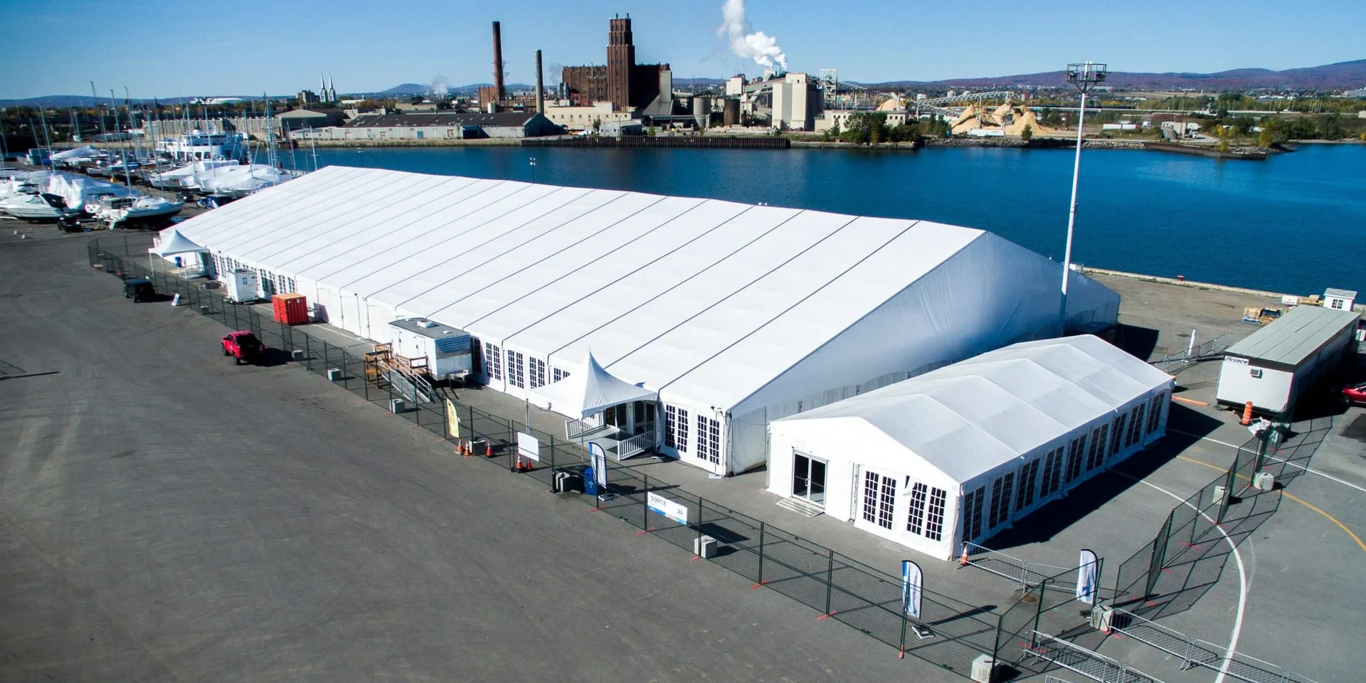 Large clearspan structure with a connected smaller structure forming an event campus